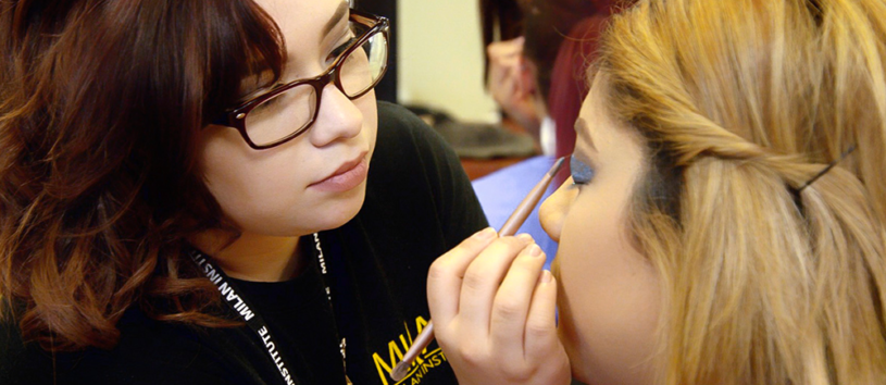 Student applying eyeshadow