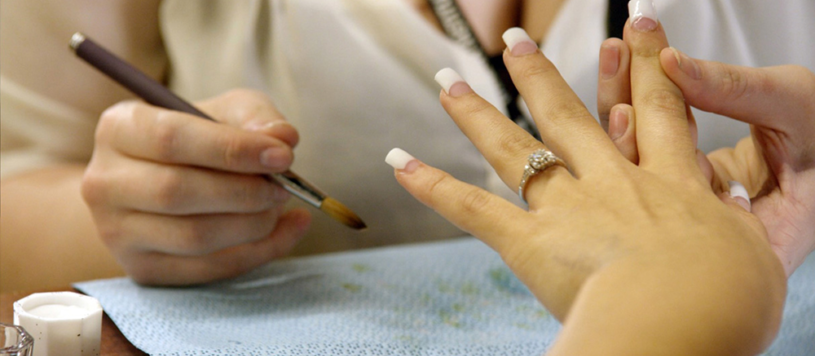 Nail tech completing a manicure
